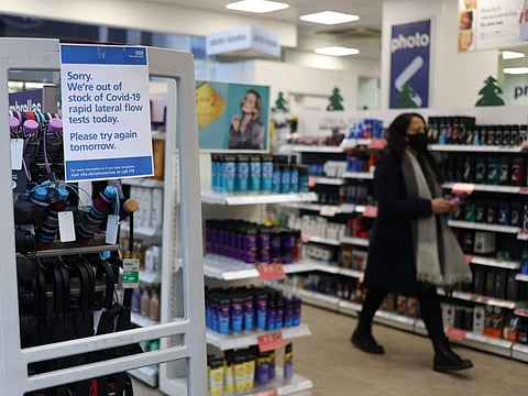 A message informing customers that there are no COVID-19 rapid lateral flow test kits available is displayed at a Boots pharmacy in London on December 29, 2021.  