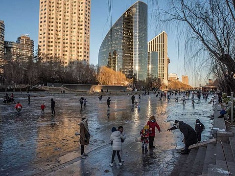 People on the frozen Lamgma River in Beijing, China, on Thursday, Dec. 29, 2022.  