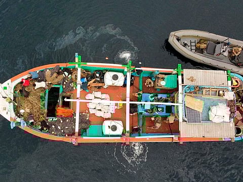 In this photo released by US Navy, US service members from coastal patrol ship USS Tempest (PC 2) and USS Typhoon (PC 5) inventory an illicit shipment of drugs while aboard a stateless dhow transiting international waters in the Arabian Sea. 