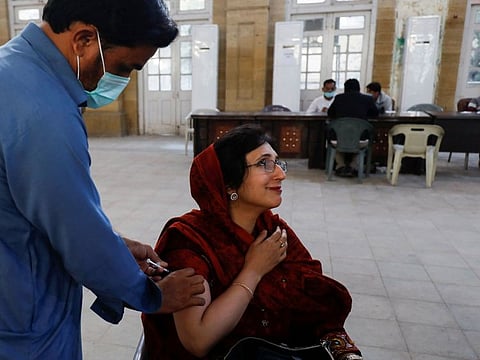 A woman receives a dose of COVID-19 vaccine in Karachi, on December 22, 2021. 