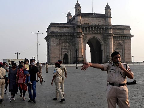 Police evacuates people from visiting Gateway of India on the eve of new year in Mumbai, on Friday, December 31, 2021. Effective Friday, police has banned people from going to any public places from 5pm to 5am daily until January 15..