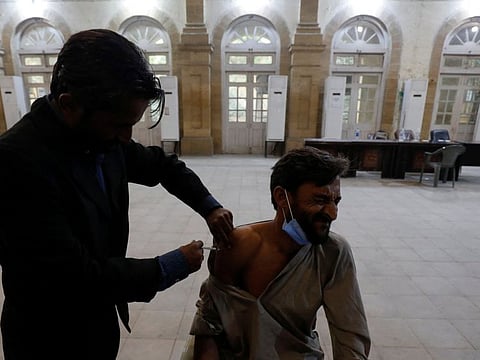 A man receives a dose of COVID-19 vaccine in Karachi, on December 27, 2021.  