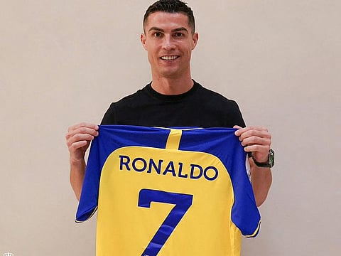 Portugal forward Cristiano Ronaldo poses with Al Nassr club's number seven jersey upon signing for the Saudi Arabian club. The 37-year-old penned a contract which will take him to June 2025.