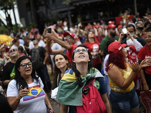 Supporters of President-elect Luiz Inacio Lula da Silva gather in front of the hotel where he is staying in Brasilia.