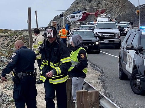 Emergency personnel respond after a Tesla plunged off a Northern California cliff along the Pacific Coast Highway, Monday, Jan. 2, 2023, near an area known as Devil's Slide, leaving four people in critical condition, a fire official said. 