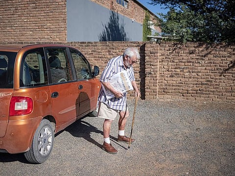 Francois Hugo, 89, owner and editor of the Noordwester, the Messenger and the Oewernuus, delivers copies of the newspapers at a computer shop in Prieska.