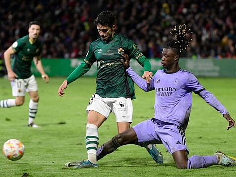 Real Madrid's midfielder Eduardo Camavinga (right) vies with Cacereno's forward Garci during the Spain's Copa del Rey (King's Cup) round of 32 match between at the Principe Felipe stadium in Caceres.