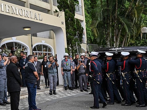 The coffin of the late Brazilian football star Pele arrives to the Santos' Memorial Cemetery after the funeral procession in Santos, Sao Paulo state, Brazil. 