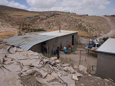 A Palestinian man walks inside his house in the West Bank Beduin community of Jinba, Masafer Yatta, Friday, May 6, 2022.  