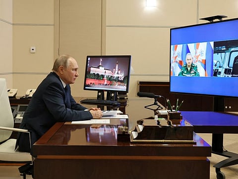 Russian President Vladimir Putin listens to the report by Defence Minister Sergei Shoigu and Commander of the Admiral Gorshkov frigate Igor Krokhmal before a ceremony to launch the Admiral Gorshkov frigate to the combat mission, via video link in Moscow, Russia January 4, 2023.