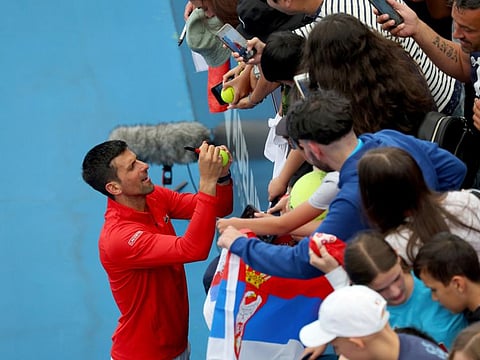 Serbia's Novak Djokovic signs autographs after defeating France's Quentin Halys during their Round of 16 match at the Adelaide International Tennis tournament in Adelaide on Thursday.