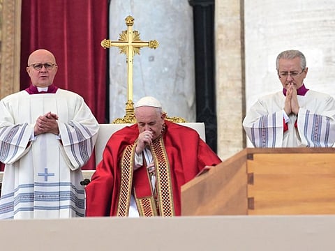 Pope Francis prays by the coffin of Pope Emeritus Benedict XVI during his funeral mass at St. Peter's square in the Vatican, on January 5, 2023.