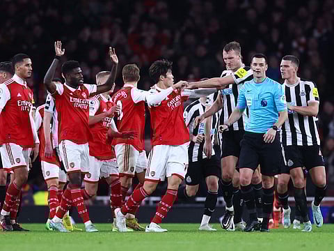 Arsenal and Newcastle players remonstrate with referee Andrew Madley during the English Premier League clash at The Emirates Stadium, North London.