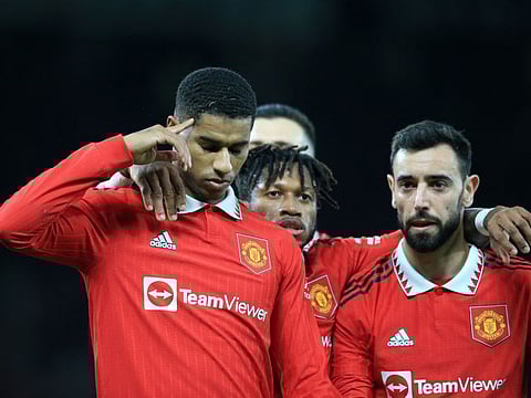 Manchester United's striker Marcus Rashford (left) celebrates with teammates after scoring during the English FA Cup third round match against Everton at Old Trafford in Manchester, north west England.
