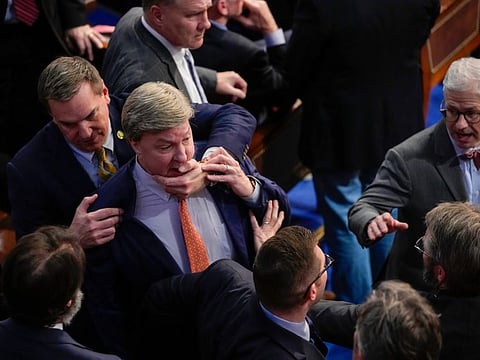 Richard Hudson, left, pulls Mike Rogers, as he angrily confronts Gaetz, telling him he would regret his decision, during the 14th round of voting for speaker on January 6, 2023. 