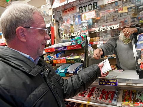 A customer buys a chance at the Mega Millions Lottery jackpot at a convenience store on the Upper East Side of Manhattan, on January 6, 2023 in New York. 