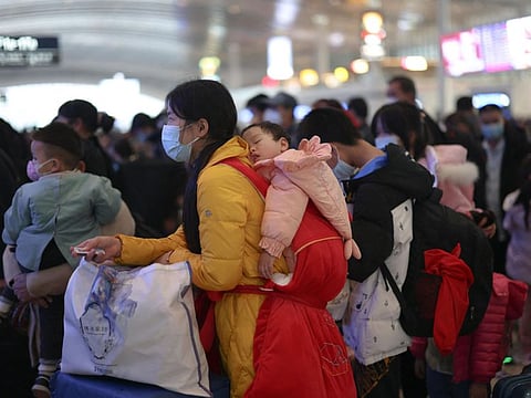 This photo taken on January 7, 2023 shows passengers preparing to board their train at Chongqing West railway station on the first day of peak travel ahead of the Lunar New Year of the Rabbit, in China's southwestern Chongqing.