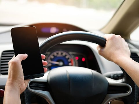 Using your phone while driving? You could face a fine of Dh800, and four black points levied on your licence. Picture used for illustrative purposes.