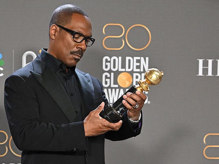 US actor Eddie Murphy poses with the Cecil B. DeMille award in the press room during the 80th annual Golden Globe Awards at The Beverly Hilton hotel in Beverly Hills, California, on January 10, 2023.