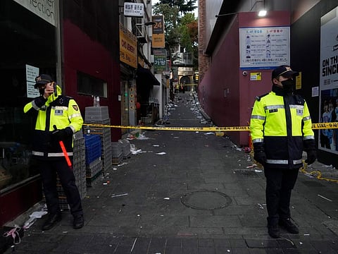 Police officers stand guard at the scene where dozens of people died during a crowd surge in Seoul, South Korea, on October 30, 2022. 
