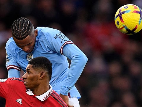 Manchester City's defender Manuel Akanji (top) jumps above Manchester United's striker Marcus Rashford during the English Premier League match at Old Trafford in Manchester, north west England.