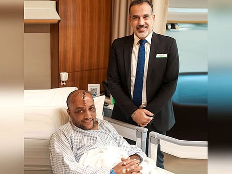 Nasser Ahmad Ghani Zada after his surgery, with Dr Khaldoun Osman by his side