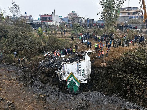 File photo: Rescuers inspect the wreckage at the site of a Yeti Airlines plane crash in Pokhara.
