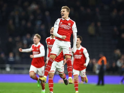 Flying high... Arsenal's Martin Odegaard celebrates after his side beat Tottenham in the Premier League to go eight points clear at the top of the table. 