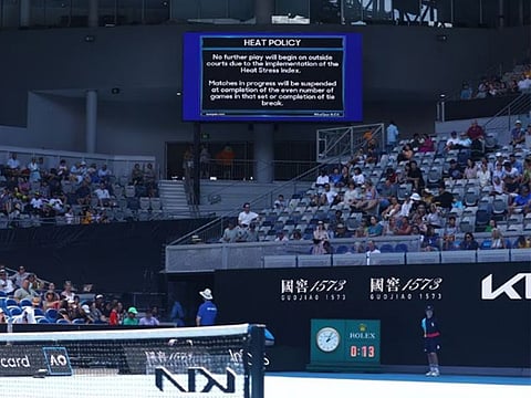 Heat policy message is displayed on the big screen as play is suspended on the outside courts due to high temperatures at the Australian Open.