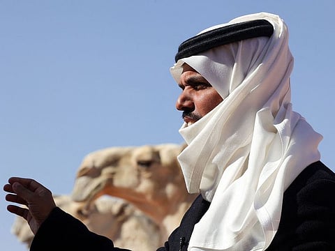 Saudi herder Mansour Al-Qatula next to his animals.
