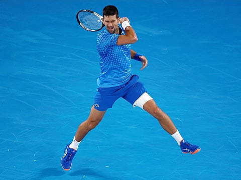 Novak Djokovic of Serbia plays a forehand return to Enzo Couacaud of France during their second round match at the Australian Open tennis championship in Melbourne, on Thursday. 