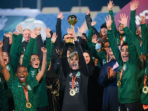 Saudi Arabia women's team, along with coach Monika Staab, celebrate their maiden win in the four-team tournament.
