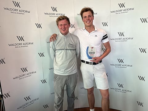 Winner of the 2023 Ras Al Khaimah Championship, Rick Hessing of Netherlands (right), alongside Joshua Humphries, Senior Executive - Tournament & Membership Coordinator, Al Hamra Golf Club.