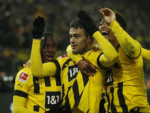 Borussia Dortmund's Giovanni Reyna celebrates after scoring their fourth goal with Jamie Bynoe-Gittens and Jude Bellingham.