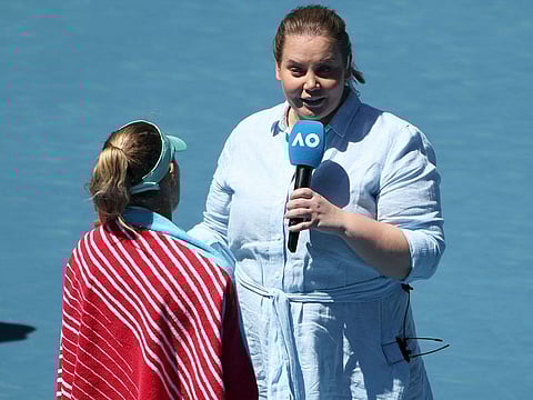  Player-turned commentator Jelena Dokic (R) talks to Poland's Magda Linette after her women's singles match against France's Caroline Garcia on day eight of the Australian Open tennis tournament in Melbourne on January 23, 2023. 