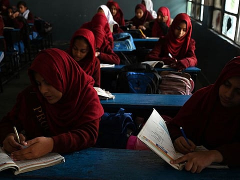 Students attend a class at a government high secondary school during a nationwide power outage in Rawalpindi on January 23, 2023. A massive power breakdown in Pakistan on January 23 affected most of the country's more than 220 million people, including in the mega cities of Karachi and Lahore.