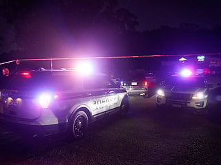 Law enforcement personnel control the scene of a shooting in Half Moon Bay, California.  