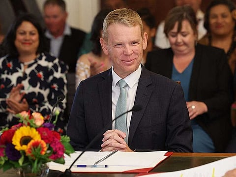 New Zealand's new Prime Minister Chris Hipkins smiles as he is sworn in by Governor General Dame Cindy Kiro during a ceremony at The Government House in Wellington on January 25, 2023. 