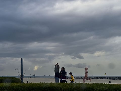 People at Sharjah Beach during the unstable conditions with overcast sky.  Photo: Ahmed Ramzan/ Gulf News