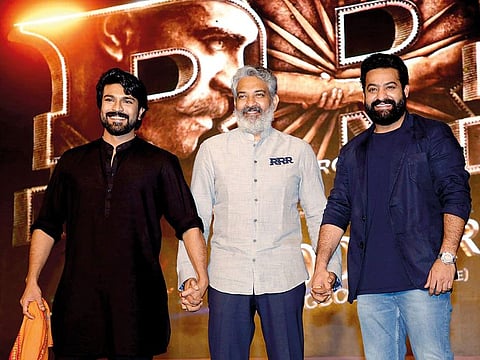 S.S. Rajamouli (centre), director of RRR, with the movie’s star protagonists, NT Rama Rao Jr (right) and Ram Charan at a promotional event for RRR in Mumbai last year