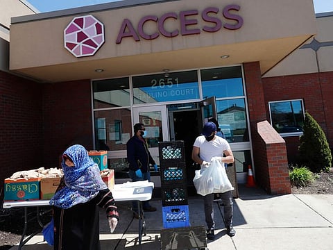 Workers at ACCESS, the Arab Community Centre for Economic and Social Services, help with meals for the Arab community in Dearborn, Michigan, on May 1, 2020.  