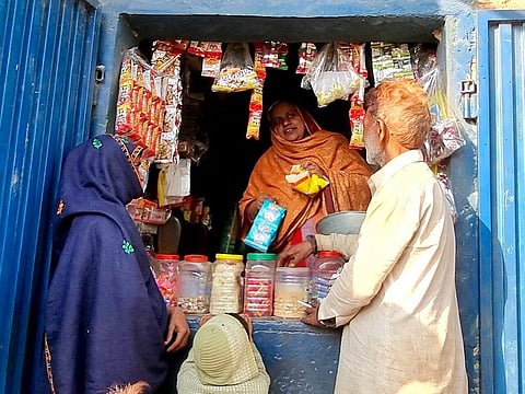 Sajida on a busy day at the shop in her home