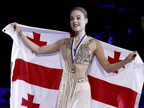 Gold medallist Georgia's Anastasiia Gubanova celebrates on the podium after winning the women's free skating