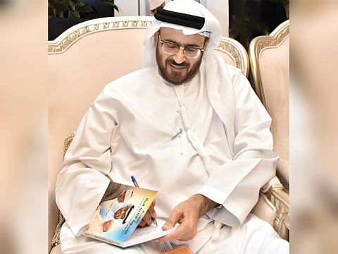 Professor Dr Jamal Sanad Al Suwaidi, Vice Chairman, Board of Trustees, Emirates Centre for Strategic Studies and Research (ECSSR), signing a copy of his new book.
