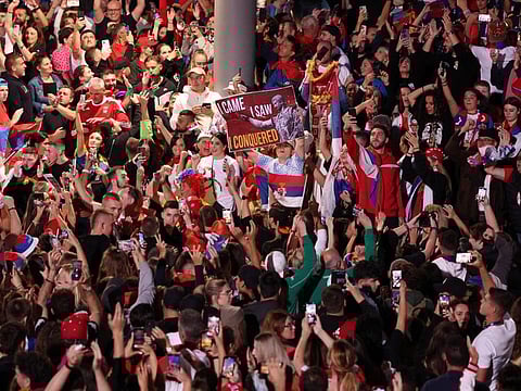 Fans are pictured with flags and posters at Melbourne Park, Melbourne, Australia.