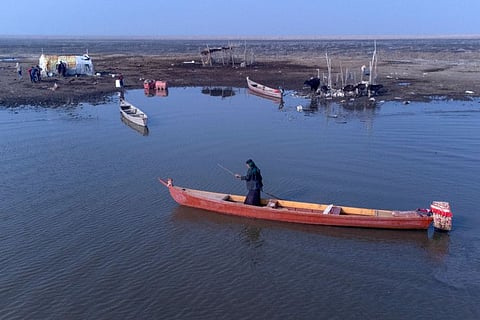 Iraqi farmers go about their chores on the banks of the southern Chibayish marshes in Dhi Qar province as water levels recover following a rainy period. 