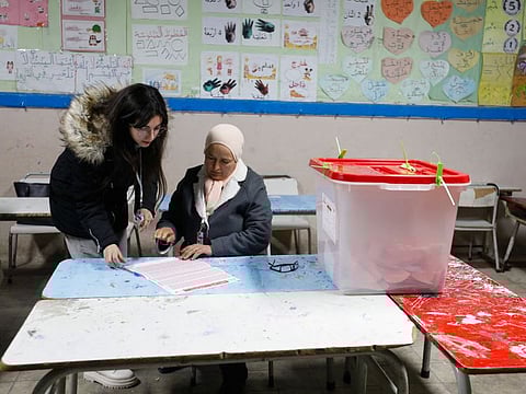 Members of the election committee work next to a closed ballot box at a polling station during the second round of the parliamentary election in Tunis, Tunisia January 29, 2023.  