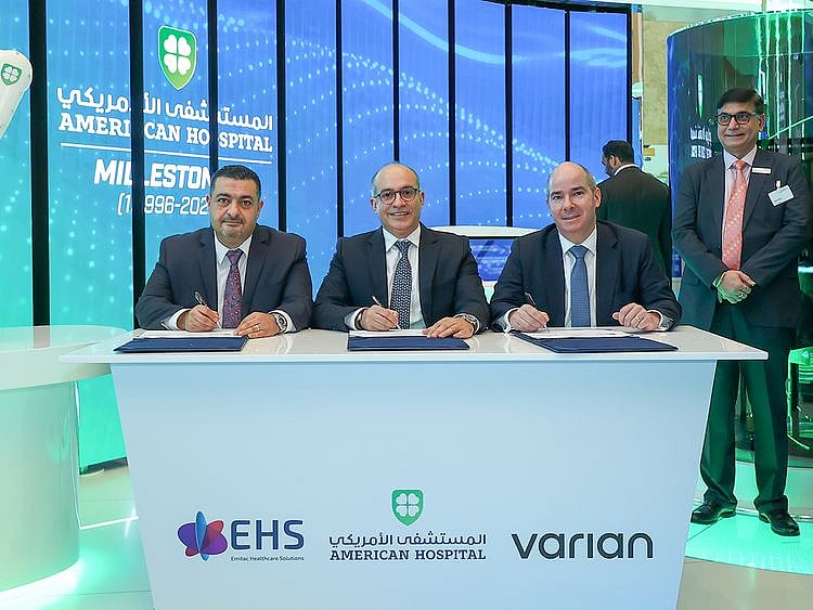 Sherif Beshara, CEO of American Hospital Dubai (centre);  Mohammed Kenanah (left), CEO of Emitac Healthcare Solutions; and Laurent Amiel, President, Radiation Oncology Solutions, Europe, Middle East and Africa at Varian, signed the agreement at Arab Health