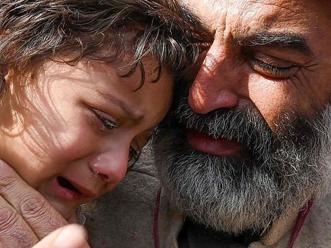 Family members of a mosque blast victim weep during a protest against the militancy and the suicide blast inside a police headquarters in Peshawar on February 1, 2023.  