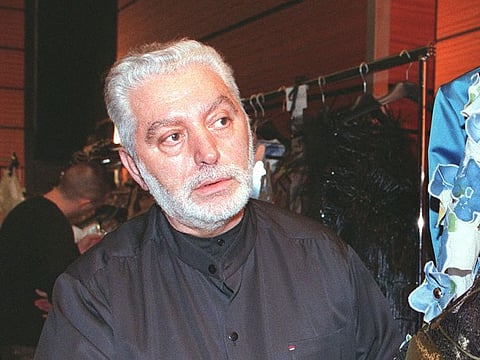 In this file photo taken on January 20, 1999, Spanish Designer Paco Rabanne checks a dress before his 1999 Spring/Summer haute-couture collection, in Paris.